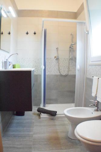 a bathroom with a shower and a toilet and a sink at DolceSosta B&B in Pulsano