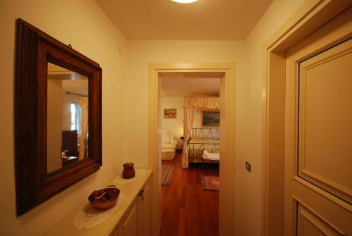 a bathroom with a mirror and a sink and a room at Villa Tuttorotto in Rovinj
