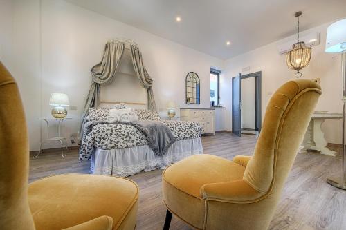 1 dormitorio con 1 cama y 2 sillas en Siena Vip B&B, en Siena