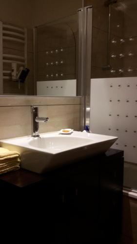 a bathroom with a white sink and a mirror at Perfect Sea View in Vila do Conde