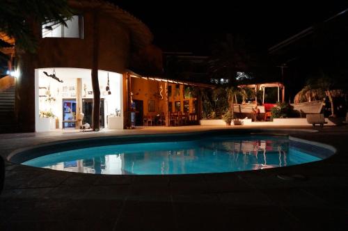 a swimming pool at night in front of a building at StevieWonderLand Playa El Yaque in El Yaque