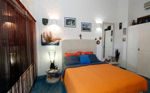 a bedroom with a bed and a cross on the wall at StevieWonderLand Playa El Yaque in El Yaque