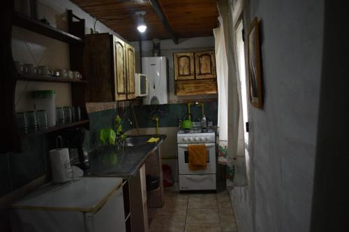 a kitchen with a sink and a stove top oven at Complejo Solitudine in Cacheuta