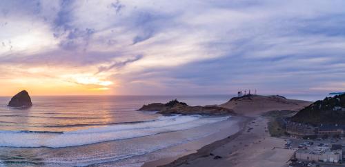 an aerial view of a beach at sunset at Headlands Coastal Lodge & Spa in Pacific City