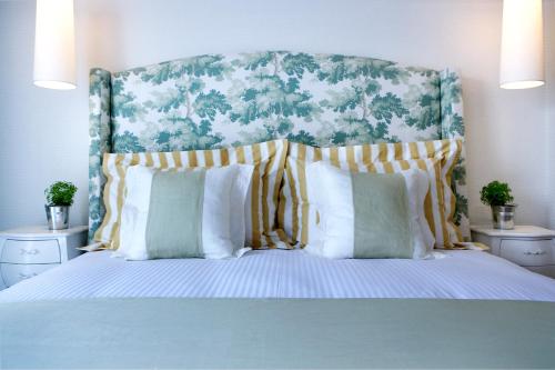 a bedroom with a large bed with pillows at Thalassa Boutique Hotel - Adults Only in Lassi