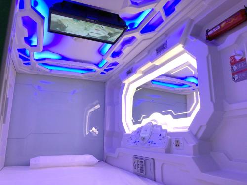an inside view of a room with a bed and a tv at izZzleep Aeropuerto Terminal 2 in Mexico City