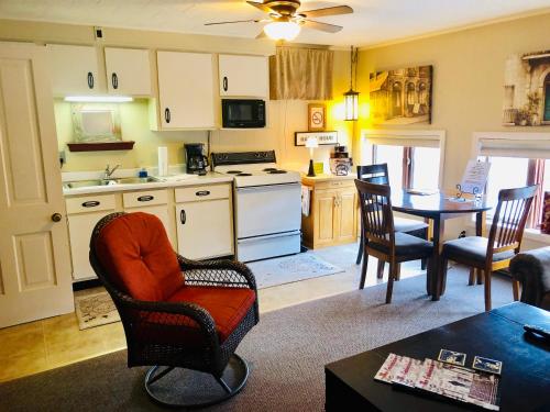 a kitchen and living room with a table and chairs at Galena Penthouse overlooking Main Street with FREE off street parking in Galena