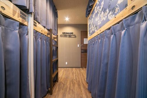 a row of volleyball racks in a locker room at IKIDANE Cozy Hotel Haneda Airport in Tokyo