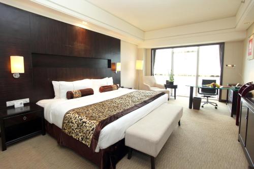 Letto o letti in una camera di Haiwaihai Grand Hotel Ma'anshan