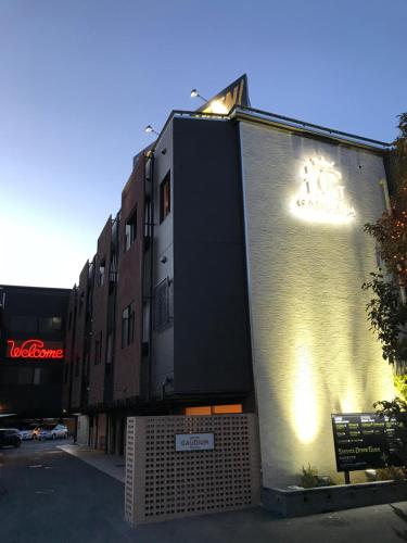 a building on the side of a street at Hotel Gaudium (Adult Only) in Kuki