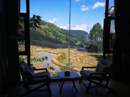a room with a window with a view of a mountain at Beyond the Terrace Residence in Yuanyang