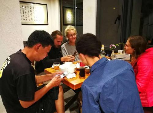 a group of people sitting at a table eating at Beyond the Terrace Residence in Yuanyang