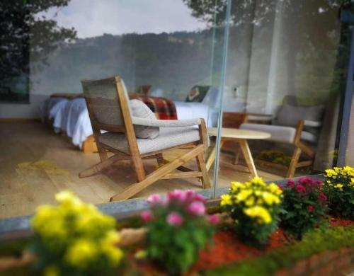 a room with a chair and a table and some flowers at Beyond the Terrace Residence in Yuanyang