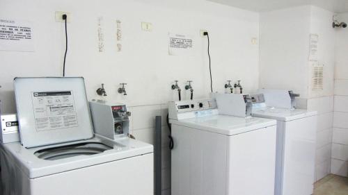 a laundry room with two machines and a washer at Oceanic Playa La Serena in La Serena