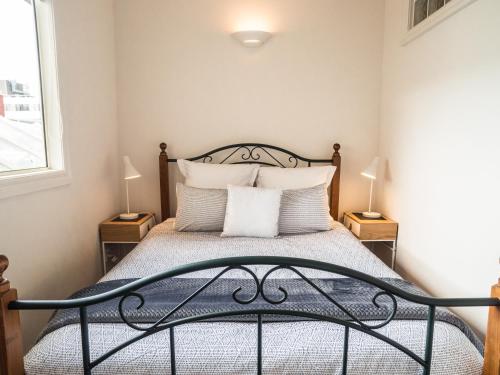 a bedroom with a bed with two night stands at U Suites on Manners in Wellington