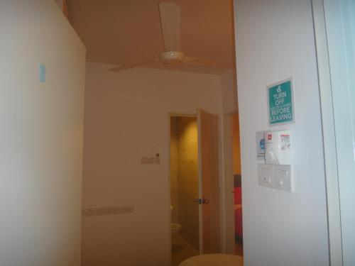 a room with a ceiling fan and a mirror at Famosa 2 Stay in Melaka