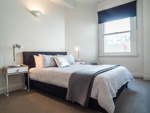 a bedroom with a bed and a window at U Suites on Manners in Wellington