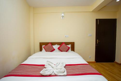 a bed with a white bedspread and white pillows at Kathmandu Boutique Hotel in Kathmandu