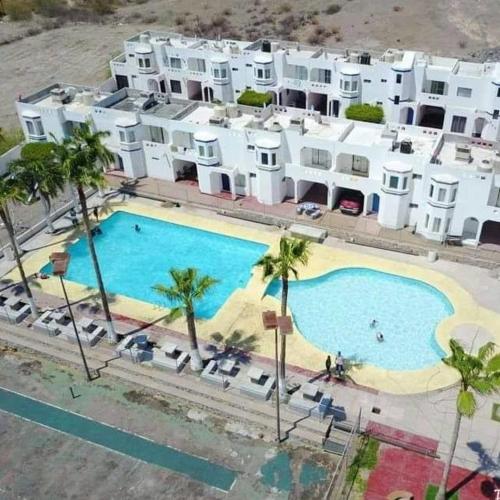 an aerial view of a building with a large swimming pool at Condominio 303 Loma Bonita, enfrente de la alberca! in San Carlos