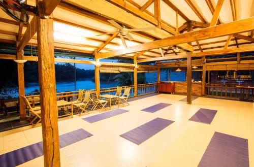 a large room with a yoga room with wooden beams at Cat Tien Jungle Lodge in Cat Tien