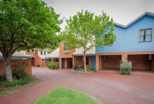 a row of houses with trees and a driveway at Middleton Beach by the BnB Collection in Albany