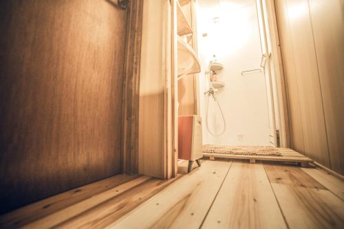 an empty room with a door and a wooden floor at Nostalgic guesthouse for 1 to 2 Females shared toilet and shower in Kyoto