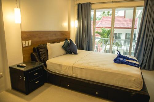 a bedroom with a large bed with a window at Stunning Republic in El Nido