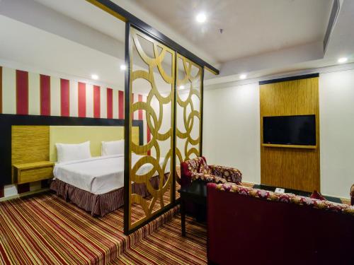 En eller flere senge i et værelse på Elaf Suites Al-Andalus