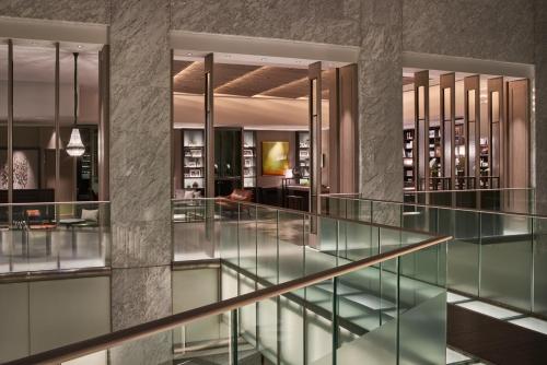 a glass staircase in a building with a lobby at The Prince Park Tower Tokyo - Preferred Hotels & Resorts, LVX Collection in Tokyo