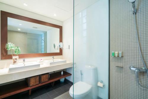 a bathroom with a sink and a toilet and a shower at Bangtao Beach Garden by RESAVA in Bang Tao Beach