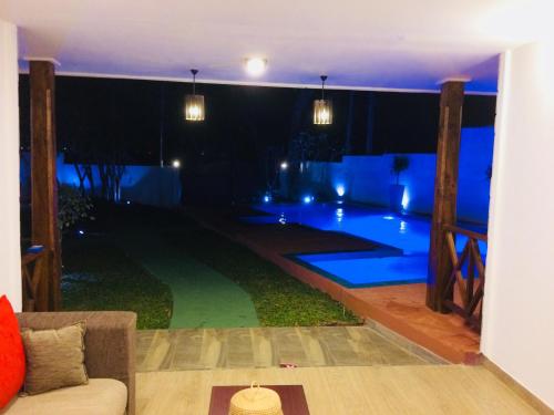 a pool in the middle of a house at night at Villa Kandy in Kandy