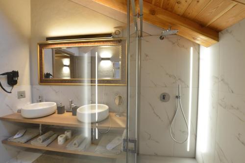 a bathroom with two sinks and a shower at Le Reve Charmant Apartments - Via Sant'Orso,2 in Aosta