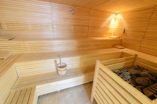 a wooden sauna with a bucket in the middle at JUFA Hotel Schladming in Schladming
