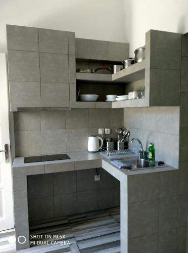 a kitchen with a sink and a counter top at Waterside Apartments in Ayia Evfimia