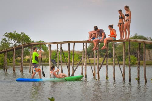 a group of people sitting on a pier in the water at Kitesurfing Lanka in Kalpitiya