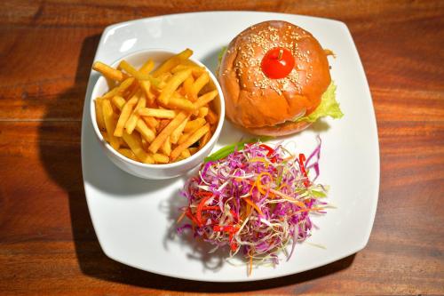a white plate with a sandwich and french fries at Kitesurfing Lanka in Kalpitiya