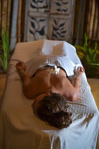 a naked man laying on a bed at Kitesurfing Lanka in Kalpitiya