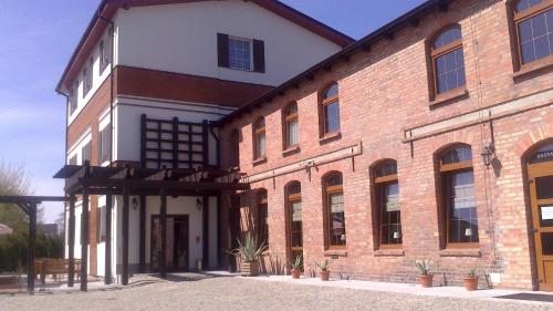 a large brick building with a large window at Winiarnia in Kwidzyn