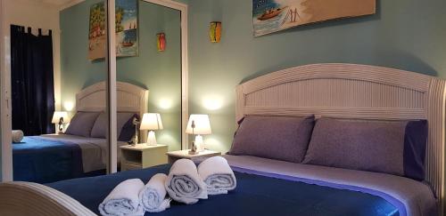 a bedroom with two beds with towels on them at Vanilla House in Bayahibe