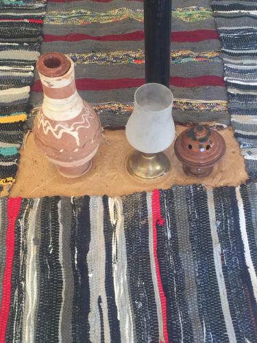 two vases sitting on a table on a rug at Nuba Narty in Aswan