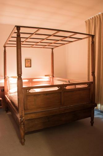 a wooden bed in a bedroom with a wooden frame at Villa Widder - Boutiquehotel in Staatsbad Brückenau
