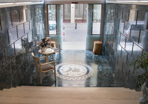 a hallway with a table and chairs in a building at Hotel Astron in Mirina