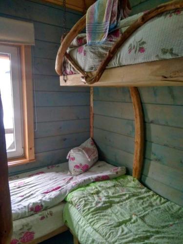 a bedroom with two bunk beds and a window at хостел "Трутень" in Vorokhta