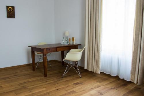 a desk and a chair in a room with a window at Philosophenvilla in Staatsbad Brückenau