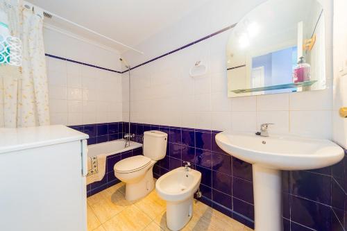 a bathroom with a toilet and a sink and a mirror at ALEGRIA ID118 in Torrevieja