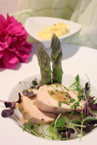a plate of food with meat and vegetables on a table at Genusshotel Diamant in Naturno
