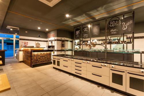 a large kitchen with white cabinets and a counter at Camping Village Roma Capitol in Ostia Antica