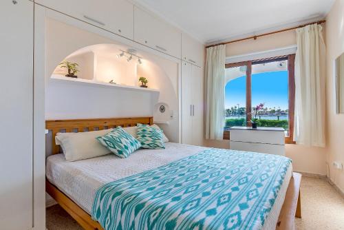 a bedroom with a large bed with a window at Apartment Carabela 2 in Alcudia