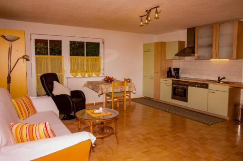 a living room with a couch and a table at Haus Bitschnau in Wald am Arlberg