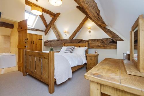 a bedroom with a large bed and a bathroom at Unit 1 Dove Farm Barns in Stoke on Trent